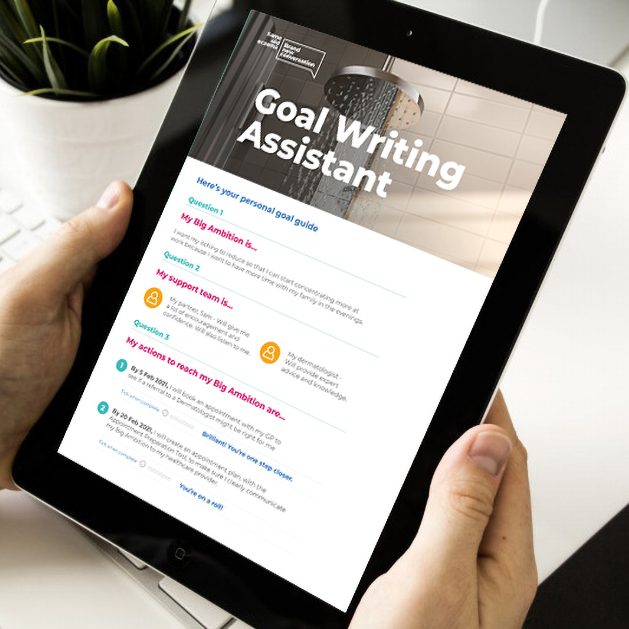 Close-up of a tablet being held by two hands with the Goal Setting Assistant tool displayed on screen